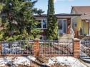 Brick exterior with a covered entry, concrete steps, and white wrought iron railings - 11345 89 Street, Edmonton, AB  - Outdoor 