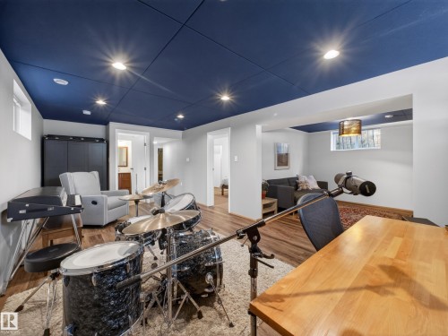 Finished lower level with recessed lighting, wood-finish flooring, and a blue ceiling - 11345 89 Street, Edmonton, AB - Indoor