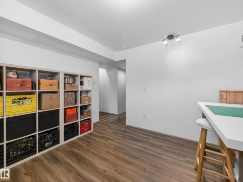 Room featuring wood-finish flooring, recessed lighting, and a track light fixture - 11345 89 Street, Edmonton, AB - Indoor