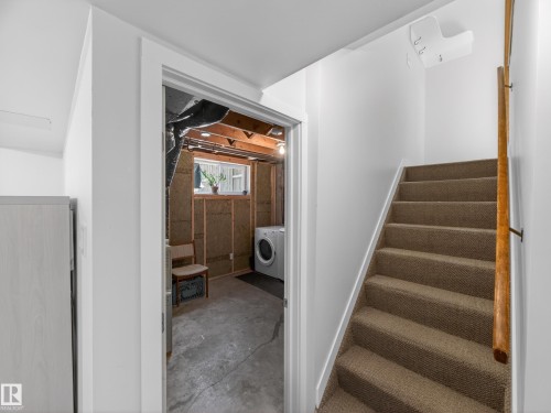Carpeted stairway with a wood handrail - 11345 89 Street, Edmonton, AB - Indoor Photo Showing Other Room