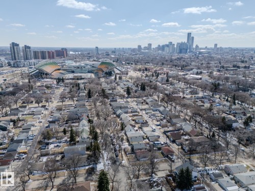 Urban residential landscape with an athletic stadium and distant city skyline - 11345 89 Street, Edmonton, AB - Outdoor With View