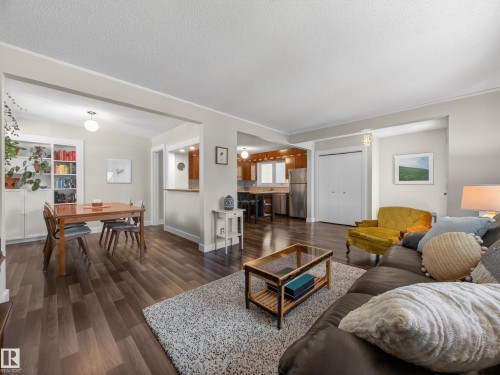 Open-concept living space featuring wood-finish flooring, light grey wall paint, and white trim - 11345 89 Street, Edmonton, AB - Indoor Photo Showing Living Room