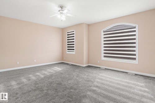 Spacious room featuring neutral-toned walls and gray carpeting - 3455 29 Street, Edmonton, AB - Indoor Photo Showing Other Room