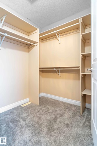 Walk-in closet featuring extensive shelving and hanging rods - 3455 29 Street, Edmonton, AB - Indoor With Storage
