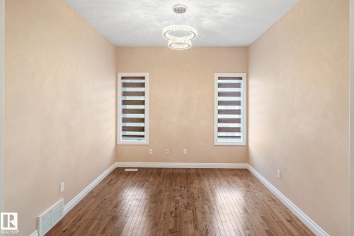 Recessed room featuring wood-finish flooring, light neutral walls, and white trim - 3455 29 Street, Edmonton, AB - Indoor Photo Showing Other Room