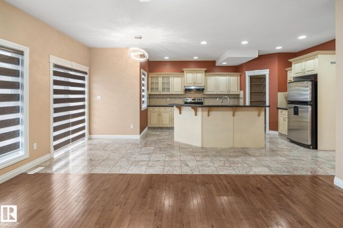 Open concept kitchen and living area featuring wood-finish flooring and tile flooring - 3455 29 Street, Edmonton, AB - Indoor Photo Showing Kitchen