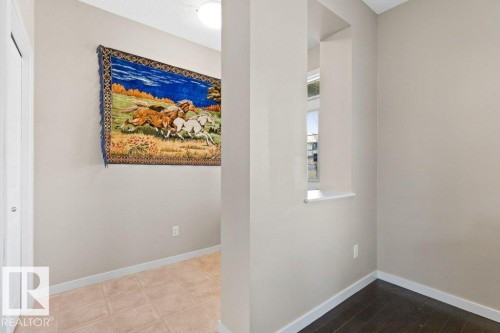 Interior hallway featuring light neutral wall paint, white trim, and a built-in recessed window niche - 575 Allard Boulevard, Edmonton, AB - Indoor Photo Showing Other Room