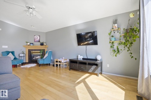 Living area with light wood-finish flooring, a ceiling fan, and recessed lighting - 2251 Brennan Court, Edmonton, AB - Indoor Photo Showing Living Room With Fireplace