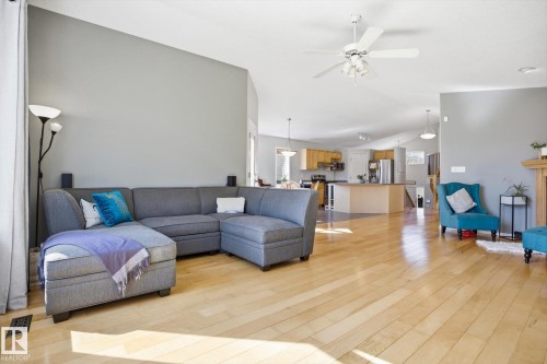 Open-concept living space featuring light wood-finish flooring and a vaulted ceiling - 2251 Brennan Court, Edmonton, AB - Indoor Photo Showing Living Room