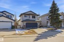 Two-story home featuring a dark gray garage door, light gray siding, and a gabled roofline - 2251 Brennan Court, Edmonton, AB  - Outdoor With Facade 
