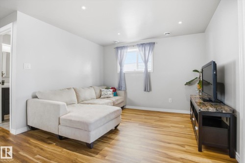 Bright living space featuring wood-finish flooring, recessed lighting, and a white trim package - 2251 Brennan Court, Edmonton, AB - Indoor