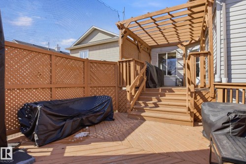 Expansive wood-finish deck with integrated stairs and a slatted wood pergola - 2251 Brennan Court, Edmonton, AB - Outdoor With Deck Patio Veranda With Exterior