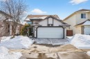 The property features a double garage with a white door, a paved driveway, and light-colored siding with dark trim - 34 Donald Place, St. Albert, AB  - Outdoor With Facade 
