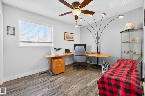 This room features light gray walls, a window with horizontal blinds, and wood-look flooring - 34 Donald Place, St. Albert, AB - Indoor