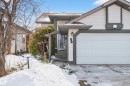 The property features a white garage door, a front entrance with steps, and a light-colored exterior with dark trim - 34 Donald Place, St. Albert, AB  - Outdoor 