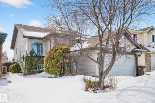 The property features a multi-level design with a prominent front-facing window and an attached garage - 34 Donald Place, St. Albert, AB - Outdoor
