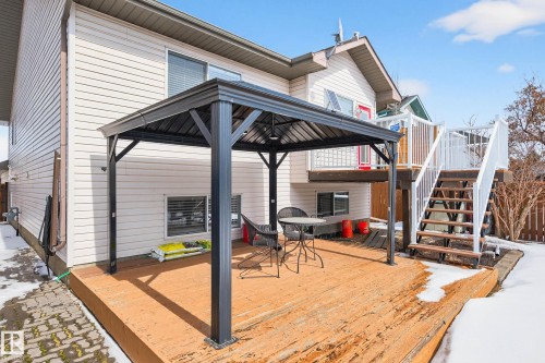 The property features a spacious wooden deck, complete with a dark-colored gazebo providing a shaded seating area - 34 Donald Place, St. Albert, AB - Outdoor With Deck Patio Veranda With Exterior