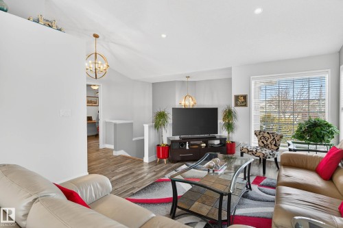 Living area featuring light gray walls, recessed lighting, and a large window with blinds - 34 Donald Place, St. Albert, AB - Indoor Photo Showing Living Room