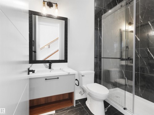 Modern bathroom featuring a single vanity with a white countertop and gray cabinetry - 6722 Crawford Way, Edmonton, AB - Indoor Photo Showing Bathroom