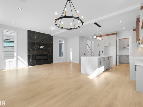 Open-concept living area featuring light wood-finish flooring and recessed lighting - 6722 Crawford Way, Edmonton, AB - Indoor
