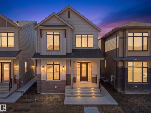 Modern two-story residence with a gabled roofline and light-toned siding - 6722 Crawford Way, Edmonton, AB - Outdoor With Facade