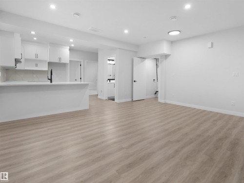 Open-concept living space featuring wood-finish flooring - 6722 Crawford Way, Edmonton, AB - Indoor