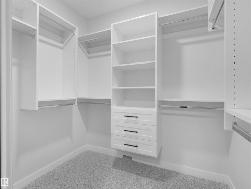 Custom closet system featuring white cabinetry and shelving - 6722 Crawford Way, Edmonton, AB - Indoor With Storage