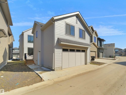 Modern two-story residence with light gray siding and a pitched roofline - 6722 Crawford Way, Edmonton, AB - Outdoor