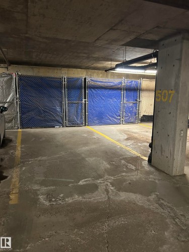 Dedicated parking space featuring concrete flooring with yellow demarcation lines - 238 2096 Blackmud Creek Drive, Edmonton, AB - Indoor Photo Showing Garage