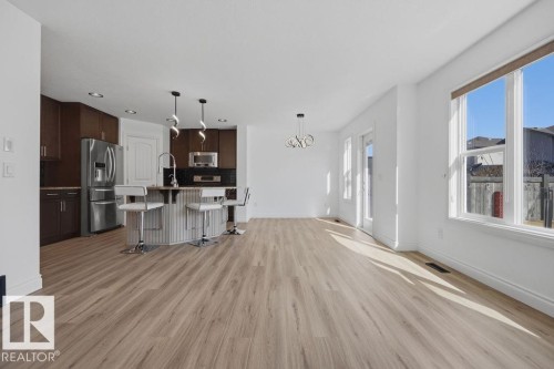 Open-concept living space with wood-finish flooring - Edmonton, AB - Indoor