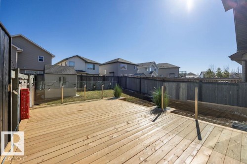 Expansive outdoor deck featuring natural wood planks - Edmonton, AB - Outdoor With Deck Patio Veranda With Exterior