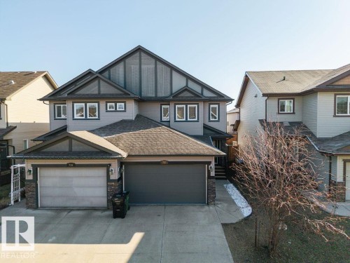 Contemporary two-story exterior featuring grey siding and dark trim - Edmonton, AB - Outdoor With Facade