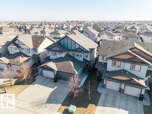 Modern residential exterior with a two-car garage, concrete driveway, and gabled roofline - Edmonton, AB - Outdoor