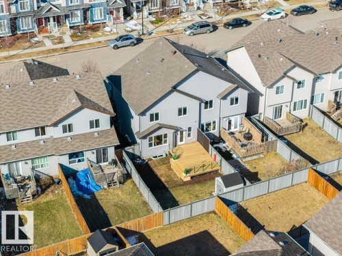 Rear exterior featuring a spacious wood deck, fenced backyard, and a storage shed - Edmonton, AB - Outdoor