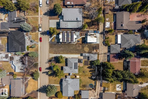 Aerial overview of a residential neighborhood featuring varied rooflines, mature trees, and an established street grid - 14013 101 Avenue, Edmonton, AB 