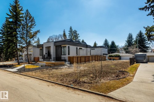 Modern exterior featuring a prominent covered entry, clean architectural lines, and a dark-toned roof - 14013 101 Avenue, Edmonton, AB 