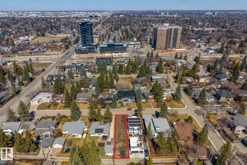 Aerial perspective showcasing a residential lot outlined in red, surrounded by mature trees and established homes - 14013 101 Avenue, Edmonton, AB 