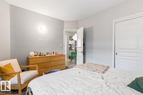 Light gray wall color with a white ceiling and baseboards - 109 10728 82 Avenue, Edmonton, AB - Indoor Photo Showing Bedroom