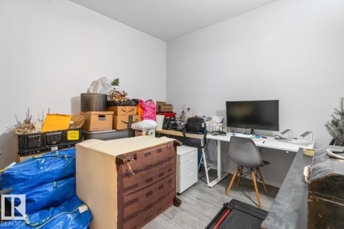 Room with light gray walls and wood-finish flooring - 109 10728 82 Avenue, Edmonton, AB - Indoor Photo Showing Office