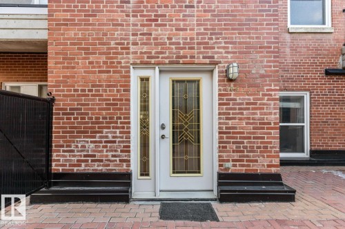 Brick facade with decorative glass entry door and sidelight - 109 10728 82 Avenue, Edmonton, AB - Outdoor With Exterior
