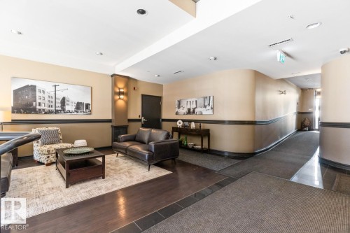 Lobby area featuring wood-finish flooring with tile accents, recessed lighting, and curved walls - 109 10728 82 Avenue, Edmonton, AB - Indoor