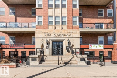 Brick exterior building featuring a stone entryway with "The Garneau" inscription - 109 10728 82 Avenue, Edmonton, AB - Outdoor With Facade