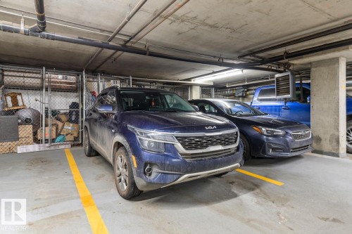 Underground parking space with concrete flooring and overhead lighting - 109 10728 82 Avenue, Edmonton, AB - Indoor Photo Showing Garage