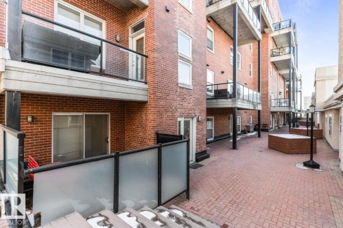 Brick exterior building featuring multiple private balconies with glass railings - 109 10728 82 Avenue, Edmonton, AB - Outdoor With Exterior