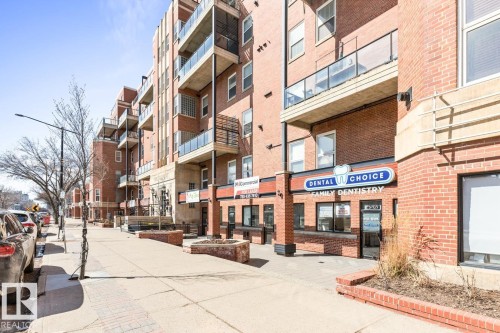 Brick building facade with multiple levels of balconies featuring clear panel railings - 109 10728 82 Avenue, Edmonton, AB - Outdoor