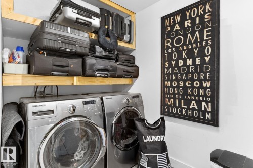 Dedicated laundry area featuring front-loading washer and dryer units - 793 Windermere Wynd, Edmonton, AB - Indoor Photo Showing Laundry Room
