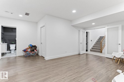 Expansive finished lower level featuring wood-finish flooring, recessed lighting, and white trim - 793 Windermere Wynd, Edmonton, AB - Indoor