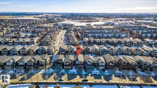 Aerial perspective showcasing a residential neighborhood with a distant cityscape - 793 Windermere Wynd, Edmonton, AB - Outdoor With View