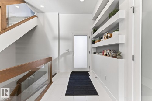 Entryway featuring a frosted glass door, white tile flooring, and recessed lighting - 793 Windermere Wynd, Edmonton, AB - Indoor Photo Showing Other Room