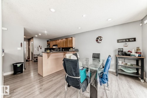 Open-concept living area featuring wood-finish flooring, recessed lighting, and a neutral wall color - 715 Hudson Place, Edmonton, AB - Indoor Photo Showing Dining Room